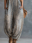 FJØRNA apricot leopard print hooded chiffon jumpsuit with long sleeves and relaxed fit, showcasing its stylish pattern and lightweight fabric.
