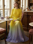 FJØRNA high waisted maxi dress with long sleeves, belt, contrast color gradient, pleated design, split-joint, and round neck.