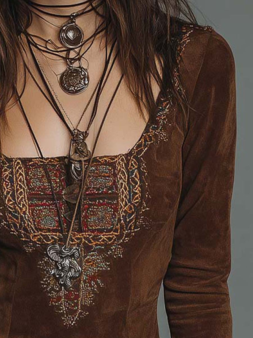 Vintage brown suede mini dress with embroidered detailing by FJØRNA, featuring a fitted silhouette and bohemian style.
