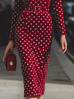FJØRNA vintage-inspired red polka dot velvet midi dress for women, showcasing a classic style with a fitted waist and flowing skirt.