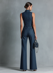 FJØRNA women's dark denim flared jumpsuit with high neck, sleeveless design, front zipper, and pants style.