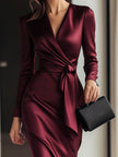FJØRNA Burgundy satin wrap dress with waist tie detail, elegant and timeless for formal occasions.