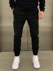 FJØRNA black cargo jogger trousers featuring multiple pockets and a relaxed fit, made from comfortable, durable fabric.