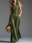 Green FJØRNA sleeveless jumpsuit with stand collar and zip-up front, positioned on a hanger with a clean background.