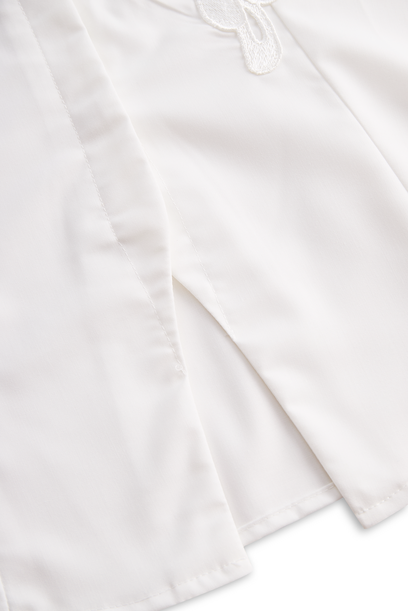 White FJØRNA women's sleeveless blouse with floral embroidery and 3D appliqué, featuring a stylish and elegant top design.