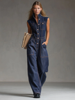 Dark blue denim FJØRNA sleeveless balloon jumpsuit with multiple pockets, relaxed fit, and casual style.
