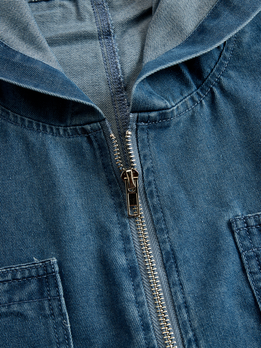 FJØRNA casual loose retro denim jumpsuit with long sleeves, hood, zipper closure, and front pockets, styled for a relaxed look.
