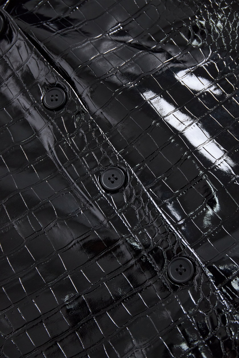 Black embossed FJØRNA women's sleeveless shirt with crocodile texture and glossy finish, showcasing a stylish, textured top.