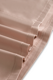FJØRNA champagne satin mini dress with square neckline and long sleeves, elegant and fitted for stylish occasions.