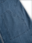 FJØRNA casual loose retro denim jumpsuit with long sleeves, hood, zipper, and front pockets, displayed on a hanger.