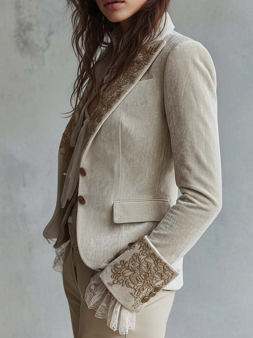 Ivory embroidered velvet blazer by FJØRNA featuring long sleeves and delicate lace cuffs, stylish and elegant for formal wear.