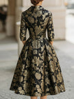 FJØRNA black and gold floral jacquard midi dress with elegant design, featuring intricate floral patterns and a fitted silhouette.