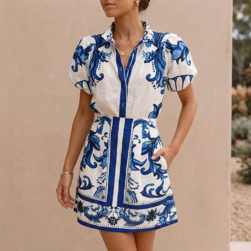 FJØRNA blue 2-piece set with puff sleeve button-front top and A-line mini skirt, featuring band collar for a stylish look