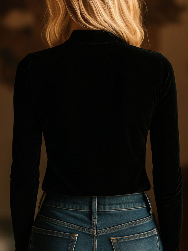 Black FJØRNA velvet V-neck long sleeve top with embroidered design, featuring a stylish and comfortable T-shirt silhouette.