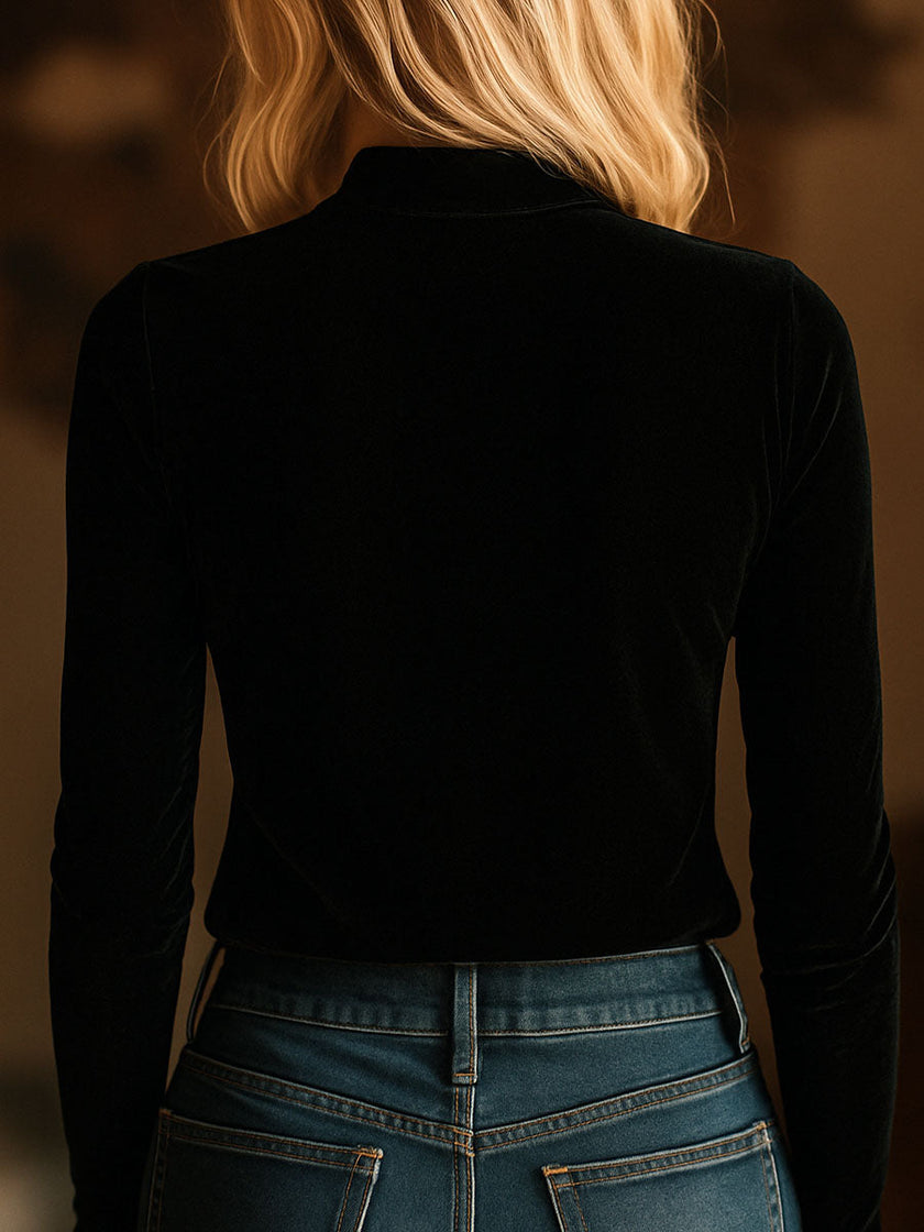 Black FJØRNA velvet V-neck long sleeve top with embroidered design, featuring a stylish and comfortable T-shirt silhouette.