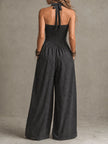 FJØRNA charcoal pinstripe halter neck wide-leg jumpsuit, stylish sleeveless one-piece with tailored fit and flowing wide-leg pants.