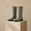 FJØRNA women's leather boots featuring sleek design, ankle height, and stitching details, perfect for stylish fall and winter wear.