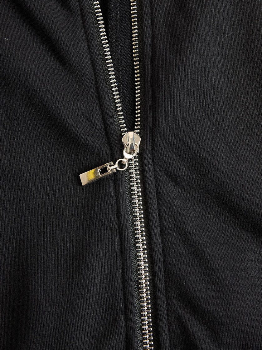 Black striped sleeveless hooded jumpsuit by FJØRNA, featuring a relaxed fit and casual style, shown on a model.