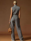 Dark grey FJØRNA cotton blend sleeveless zip-up jumpsuit displayed on a model, featuring a fitted waist and casual style.