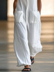 White linen sleeveless wide-leg jumpsuit for women by FJØRNA, featuring a relaxed fit and elegant, breathable fabric.