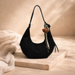 FJØRNA unisex adjustable shoulder bag with sleek design, suitable as a women's accessories bag, featuring a comfortable strap.