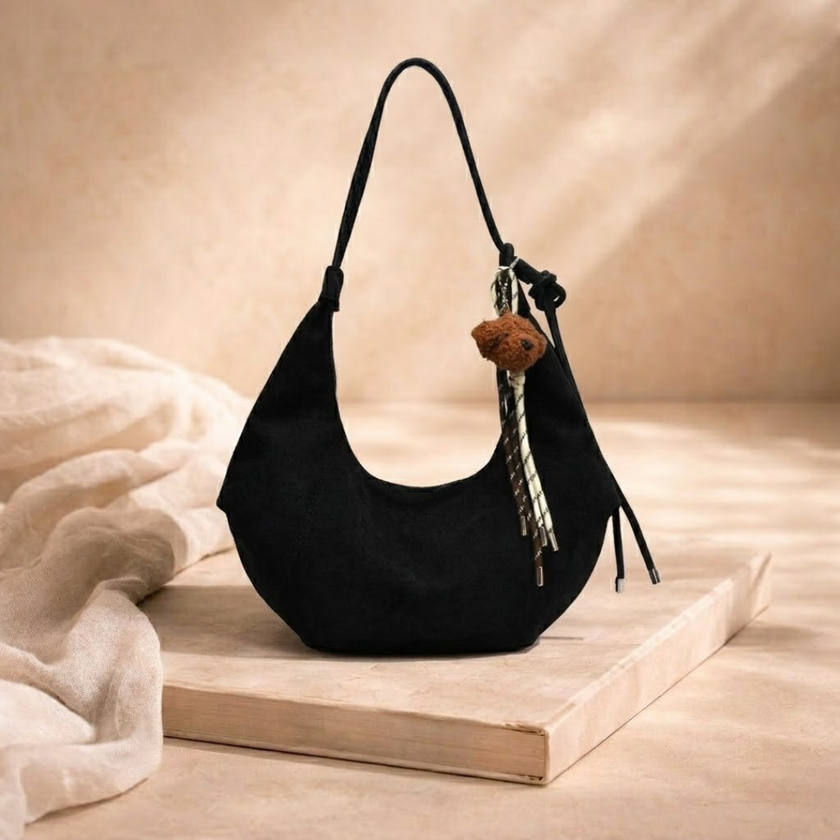 FJØRNA unisex adjustable shoulder bag with sleek design, suitable as a women's accessories bag, featuring a comfortable strap.