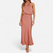 FJØRNA draped sleeveless halter maxi dress displayed on a hanger with flowing fabric and elegant design.