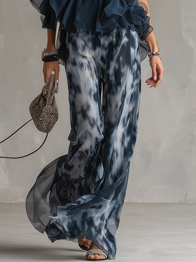 Navy blue printed wide-leg trousers for women by FJØRNA, featuring a relaxed fit and stylish pattern, displayed on a model.