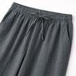 Men's linen drawstring trousers by FJØRNA, lightweight and breathable men's pants with a relaxed fit and adjustable waistband.