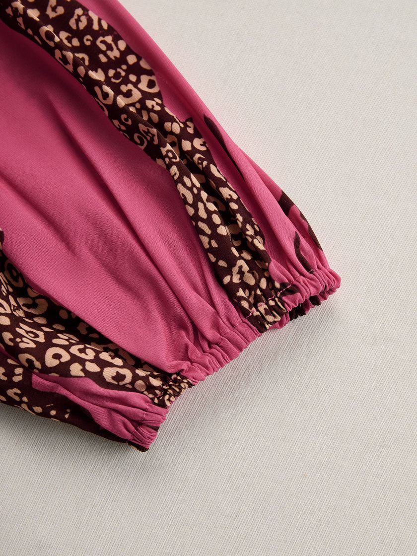 Rose red leopard print chiffon jumpsuit with long sleeves by FJØRNA, featuring a flowing fabric and stylish fit.