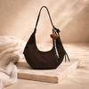 FJØRNA adjustable unisex shoulder bag with sleek design, featuring a strap and compact accessory for women.