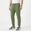 Men's slim fit FJØRNA cotton cargo trousers, shown in a neutral color, with multiple pockets and a tailored fit.