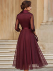 FJØRNA elegant wrap midi dress for women with sheer sleeves, showcasing a sophisticated, flowing design for stylish occasions.
