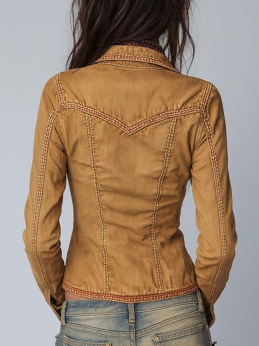 Camel washed slim-fit denim jacket for women by FJØRNA, displayed on a hanger with visible stitching and classic denim details.