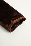 FJØRNA brown velvet colour-block lapel coat with pockets, stylish and cozy for cold weather, detailed close-up of the coat's design.