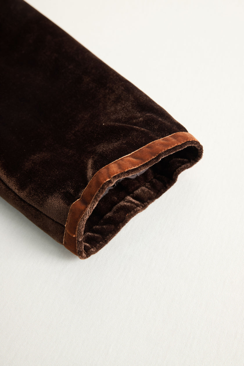 FJØRNA brown velvet colour-block lapel coat with pockets, stylish and cozy for cold weather, detailed close-up of the coat's design.