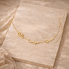 Unisex personalized jewelry necklace with engraved pendant by FJØRNA, showcasing a sleek, modern design on a silver chain.