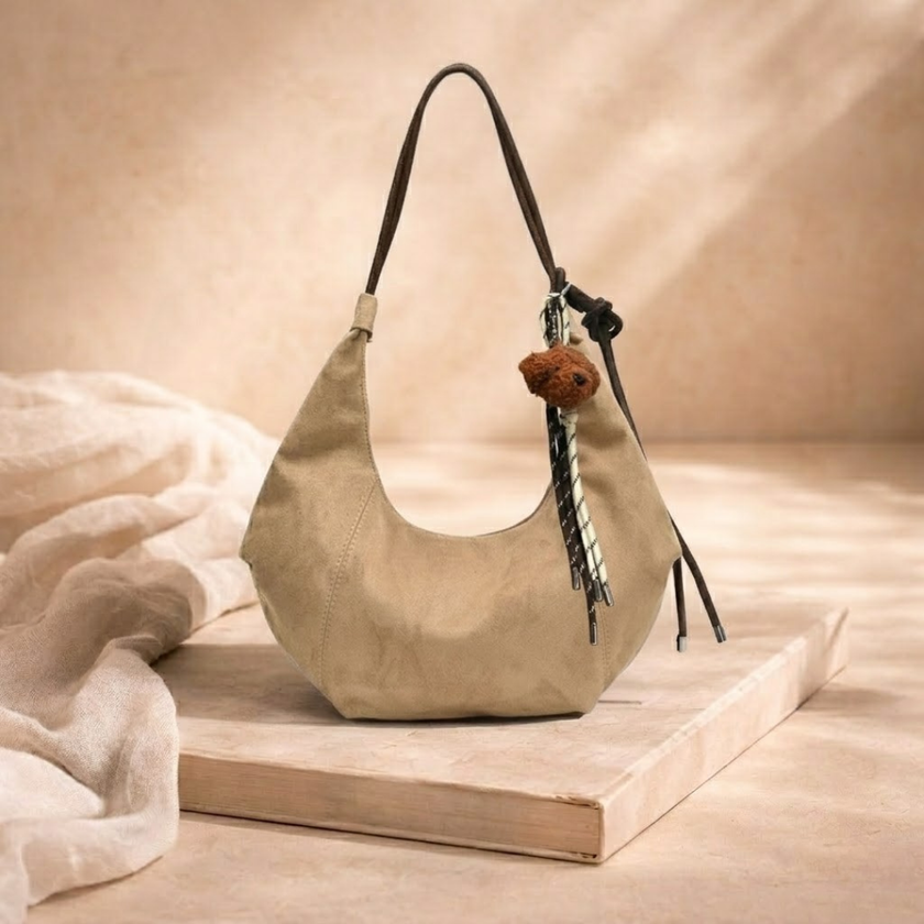 FJØRNA adjustable unisex shoulder bag accessory with sleek design, featuring a strap and compact storage for women.