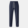 FJØRNA men's wide leg joggers with drawstring waist, featuring a relaxed fit and soft fabric, shown on a model.
