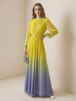 FJØRNA high waisted maxi dress with long sleeves, belt, contrast color gradient, pleated details, and round neck.