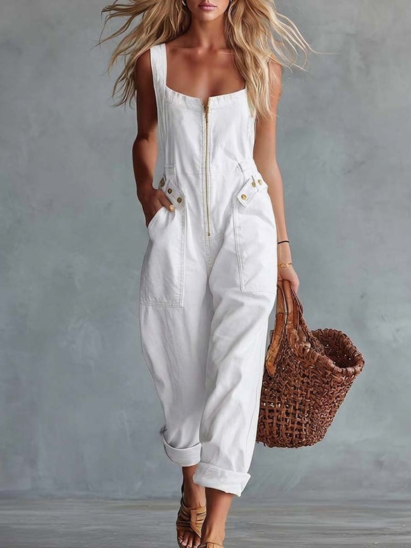 Light yellow denim jumpsuit with square neckline and zip-front closure, by FJØRNA, shown on model.