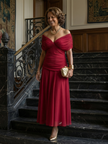 Elegant FJØRNA women's off-shoulder midi bodycon dress displayed on a hanger, featuring a fitted silhouette and stylish design.