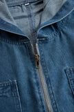 FJØRNA casual loose retro denim jumpsuit with long sleeves, hood, zipper, and front pockets, styled for a relaxed look.