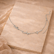 Unisex personalized jewelry necklace by FJØRNA with engraved pendant, showcasing elegant design and custom details.