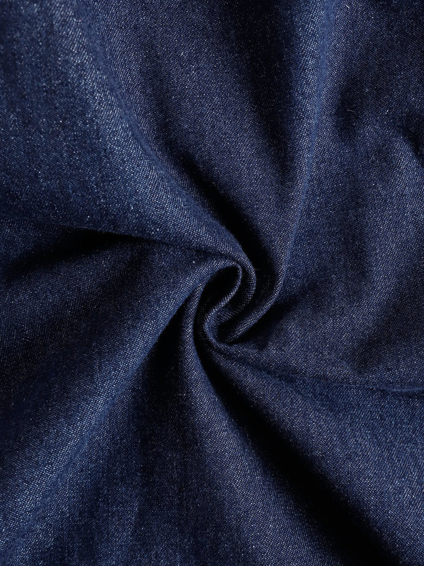 Dark blue denim FJØRNA sleeveless balloon jumpsuit with multiple front and side pockets, relaxed fit, and wide-leg design.