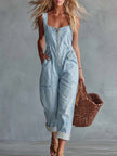 Light yellow denim jumpsuit with square neckline and zip front by FJØRNA, shown on a model.