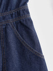 Dark blue denim FJØRNA sleeveless balloon jumpsuit with multiple pockets, featuring a relaxed fit and stylish design.