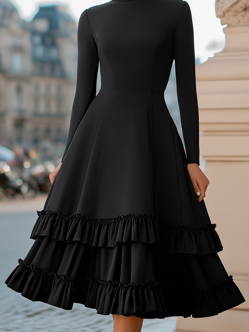 FJØRNA high-neck A-line tiered ruffle midi dress displayed on a model, featuring flowing fabric and layered ruffle details.