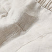 FJØRNA women's lightweight summer trousers with high waist, wide-leg fit, and front pockets, shown in a casual outdoor setting.