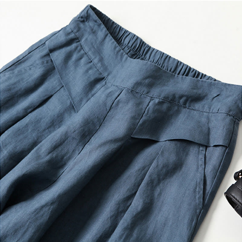 FJØRNA lightweight summer women's trousers with high waist, wide leg, and front pockets, suitable for warm weather.